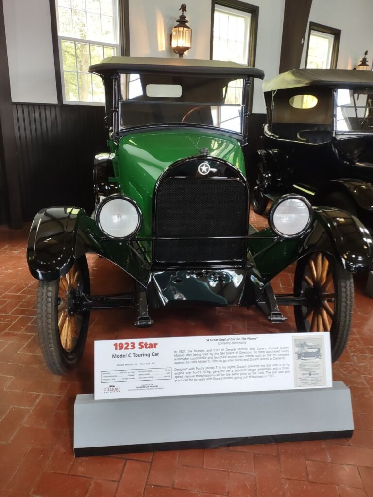 A restored green Star car on display in a museum